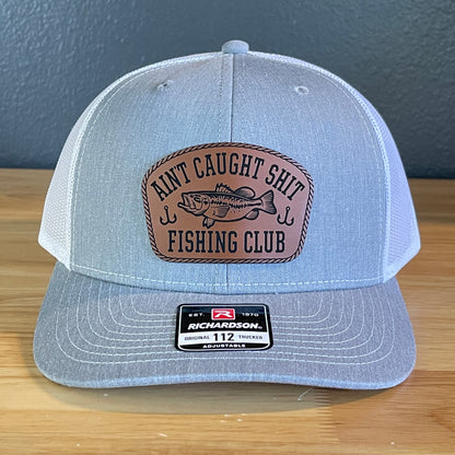 Ain't Caught Shit Fishing Club Leather Patch Trucker Hat. Richardson 112.