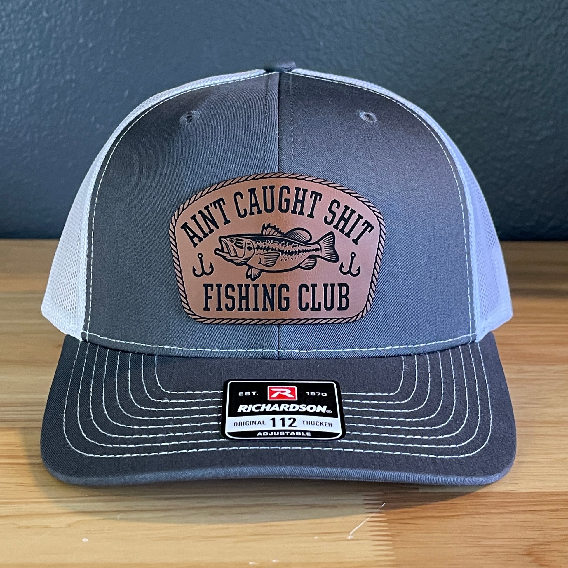 Ain't Caught Shit Fishing Club Leather Patch Trucker Hat. Richardson 112.