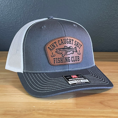 Ain't Caught Shit Fishing Club Leather Patch Trucker Hat. Richardson 112.