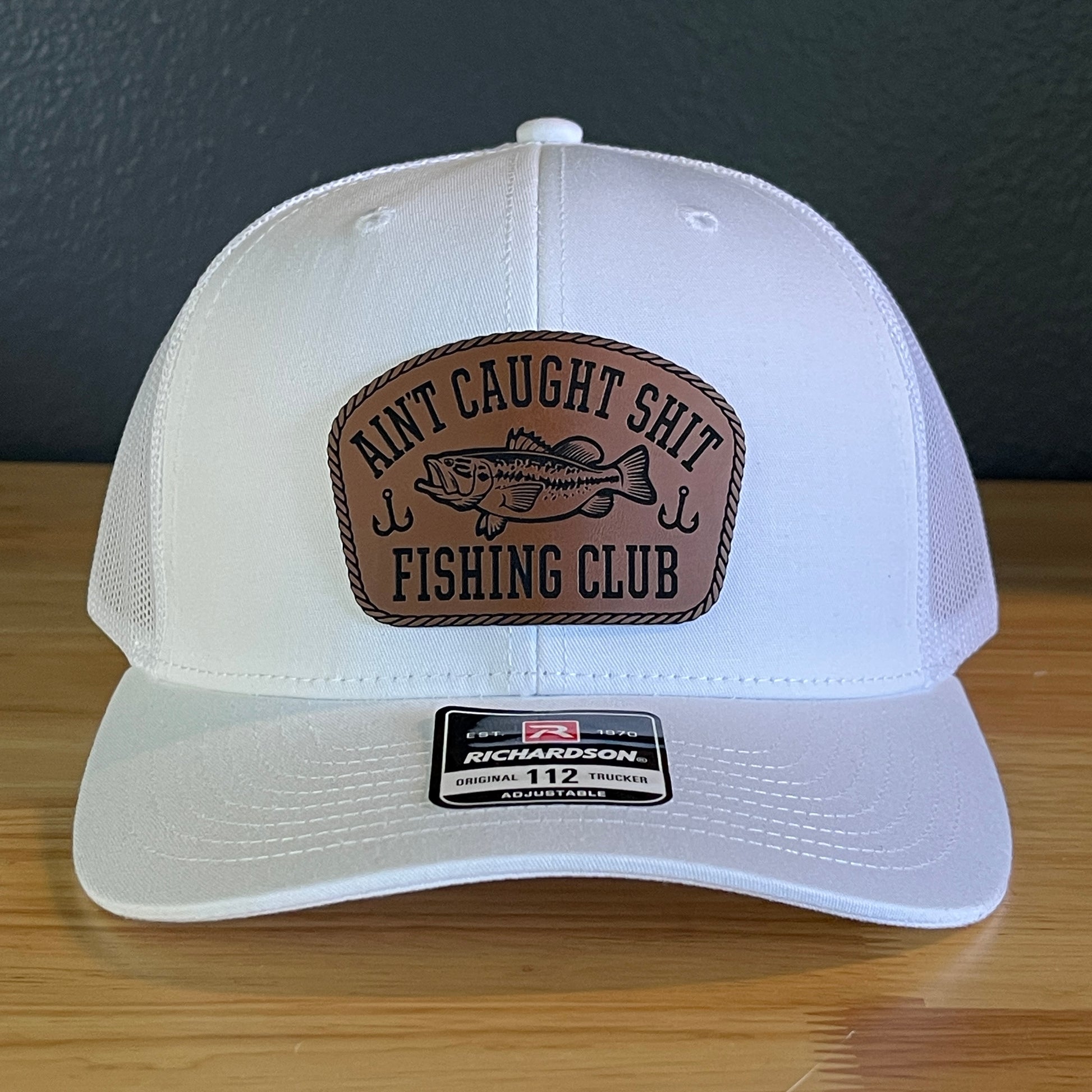 Ain't Caught Shit Fishing Club Leather Patch Trucker Hat. Richardson 112.