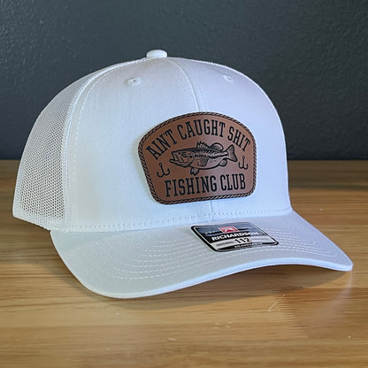 Ain't Caught Shit Fishing Club Leather Patch Trucker Hat. Richardson 112.
