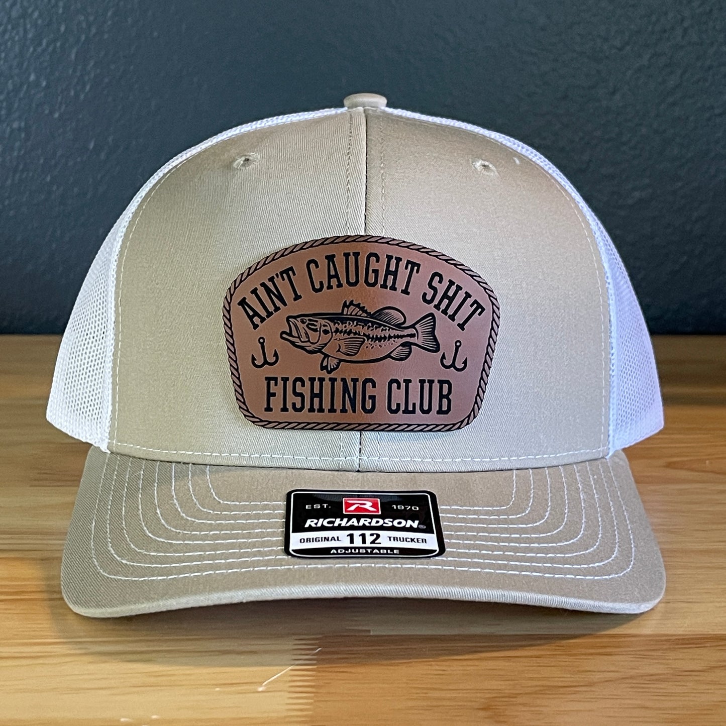 Ain't Caught Shit Fishing Club Leather Patch Trucker Hat. Richardson 112.