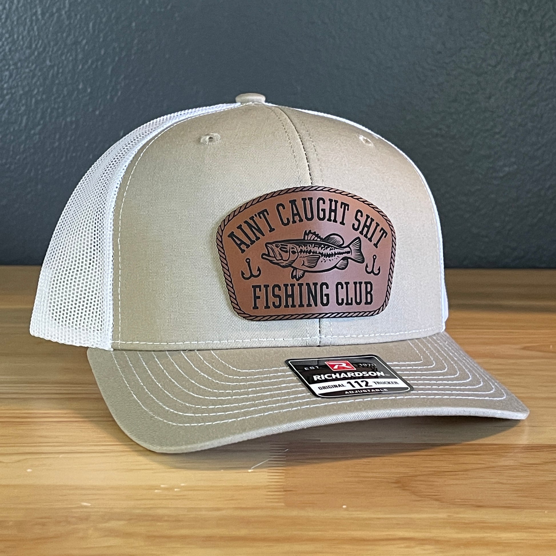 Ain't Caught Shit Fishing Club Leather Patch Trucker Hat. Richardson 112.