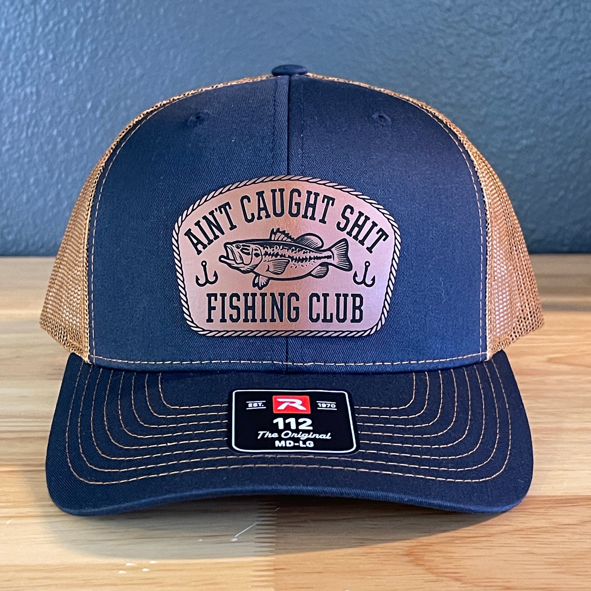Ain't Caught Shit Fishing Club Leather Patch Trucker Hat. Richardson 112.