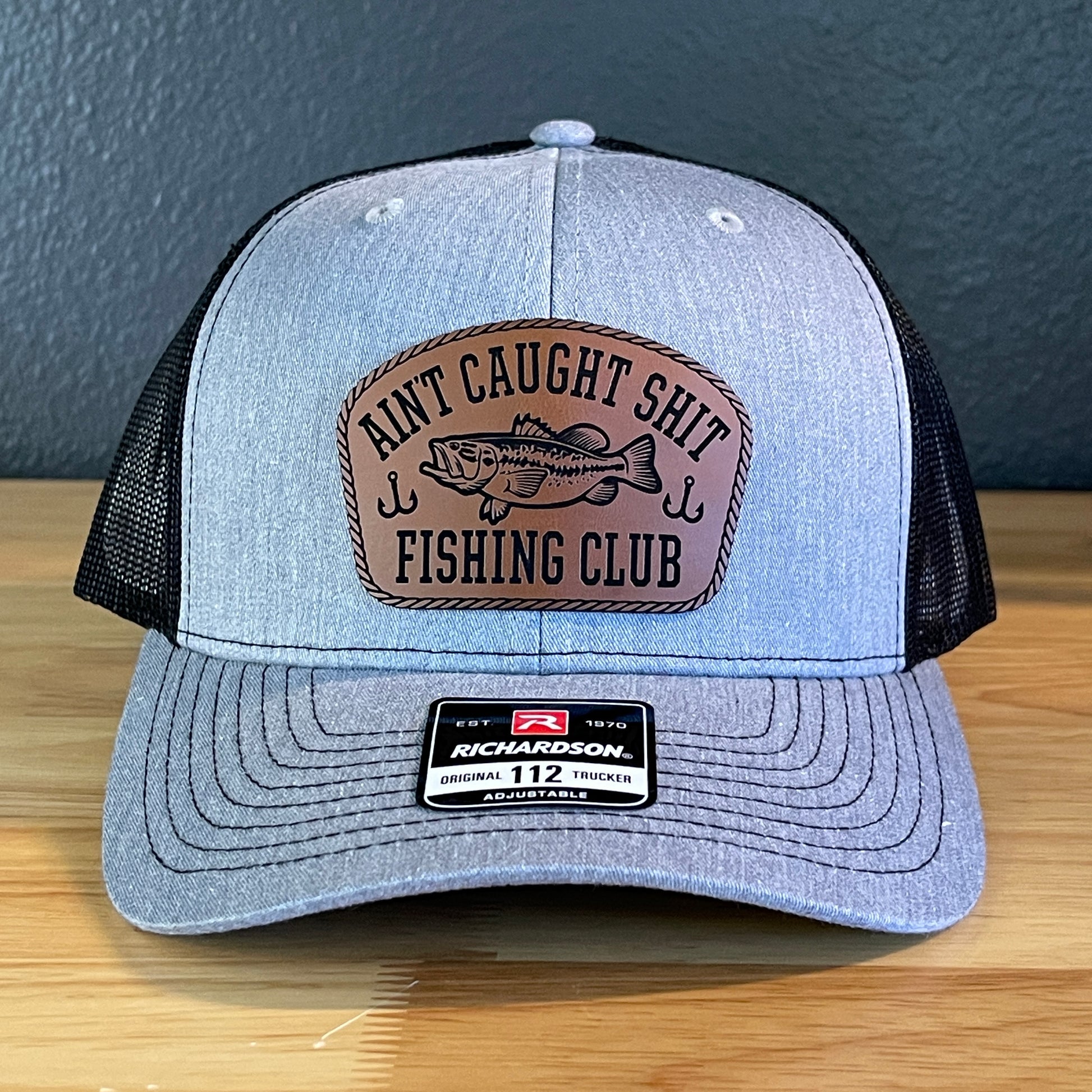 Ain't Caught Shit Fishing Club Leather Patch Trucker Hat. Richardson 112.