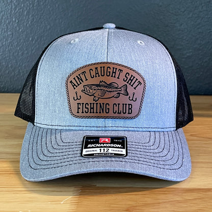 Ain't Caught Shit Fishing Club Leather Patch Trucker Hat. Richardson 112.