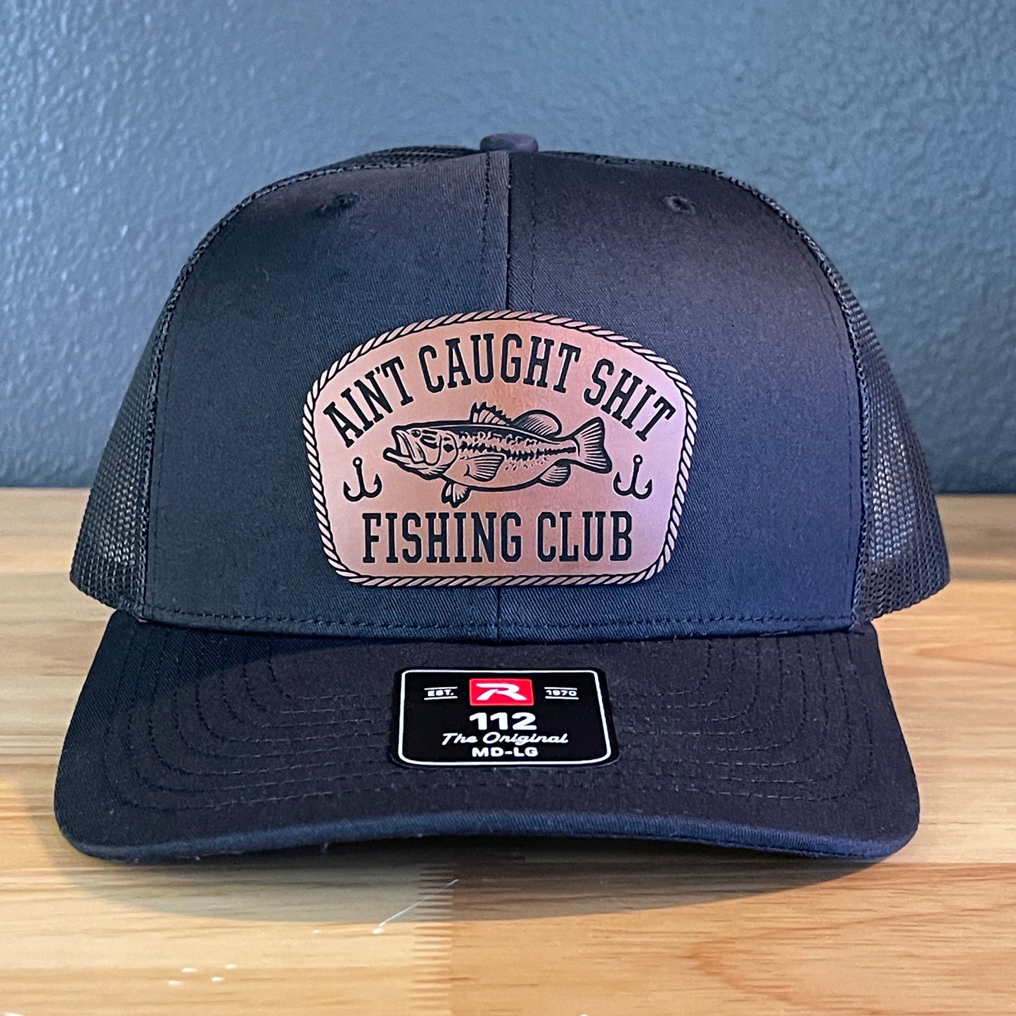 Ain't Caught Shit Fishing Club Leather Patch Trucker Hat. Richardson 112.