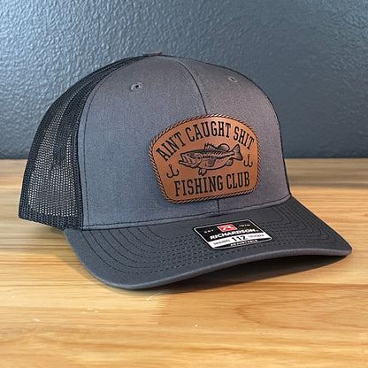 Ain't Caught Shit Fishing Club Leather Patch Trucker Hat. Richardson 112.