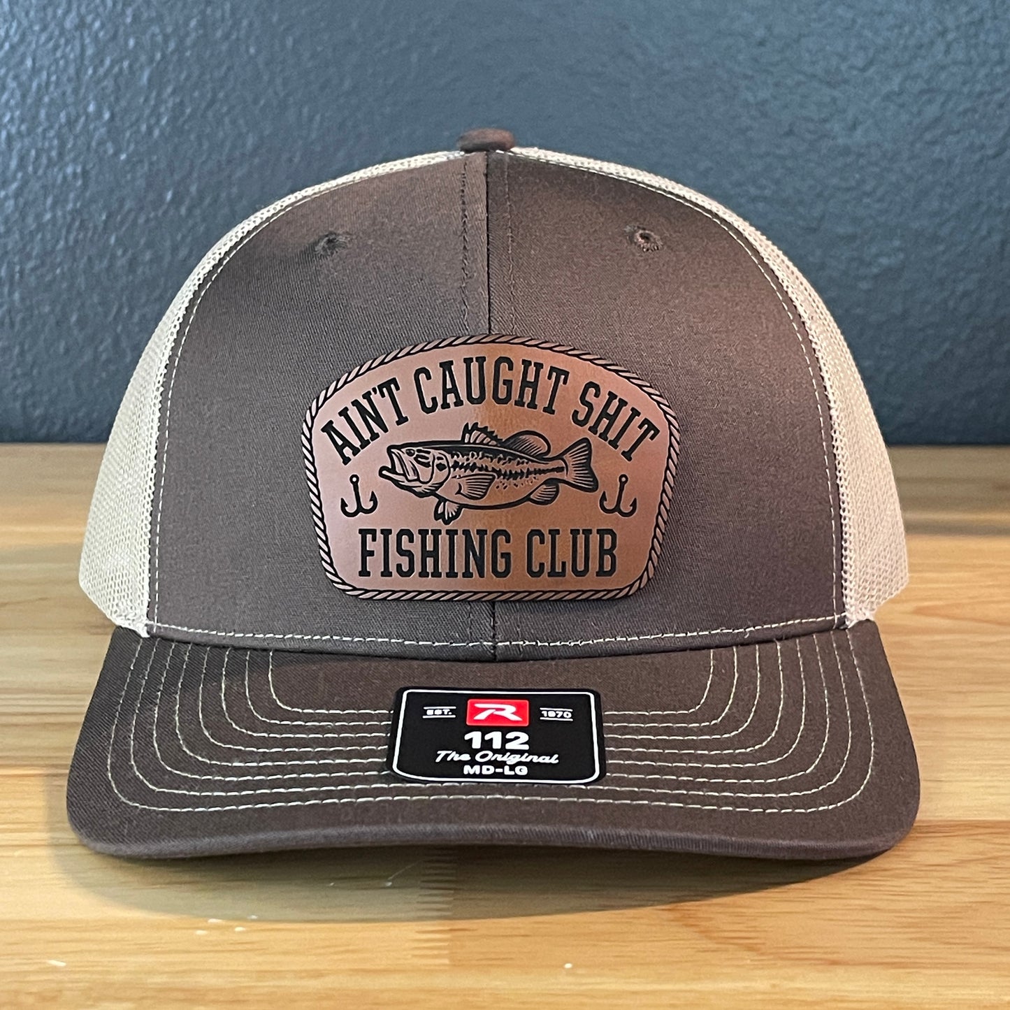 Ain't Caught Shit Fishing Club Leather Patch Trucker Hat. Richardson 112.