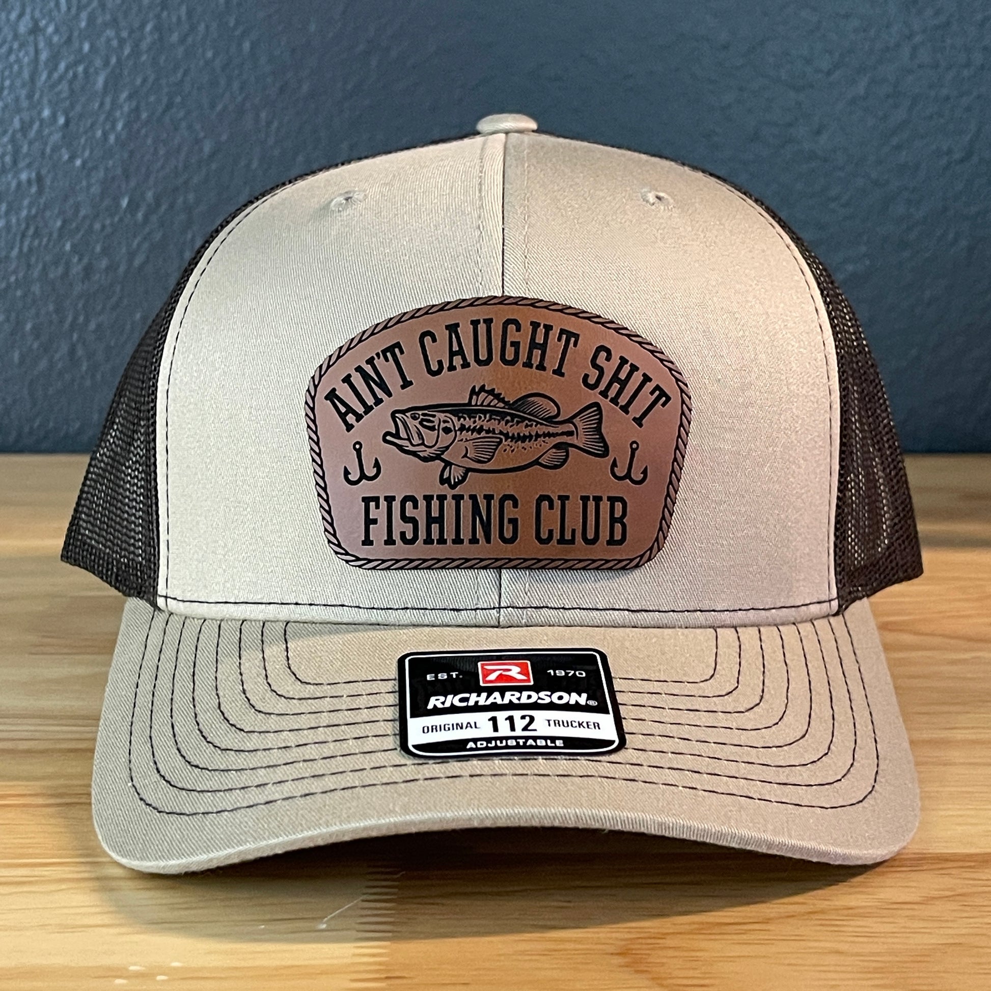 Ain't Caught Shit Fishing Club Leather Patch Trucker Hat. Richardson 112.