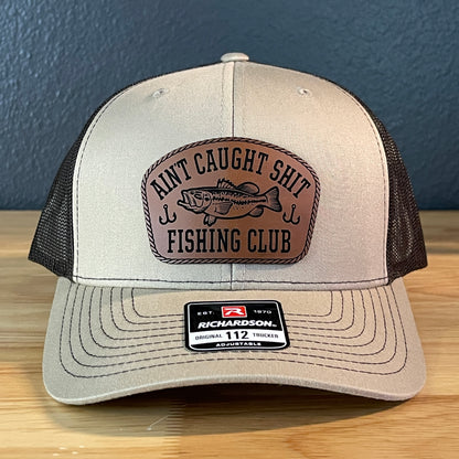 Ain't Caught Shit Fishing Club Leather Patch Trucker Hat. Richardson 112.