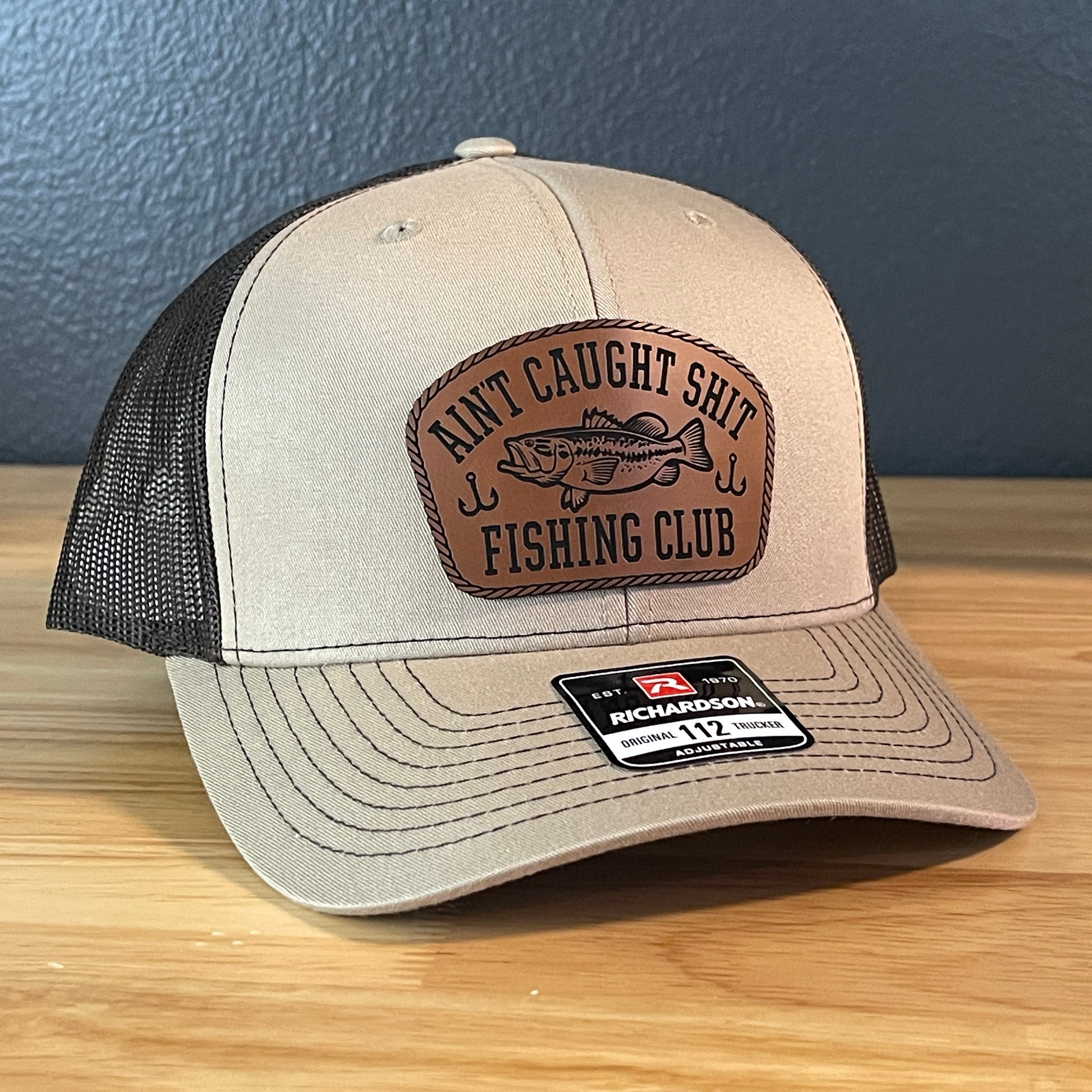 Ain't Caught Shit Fishing Club Leather Patch Trucker Hat. Richardson 112.