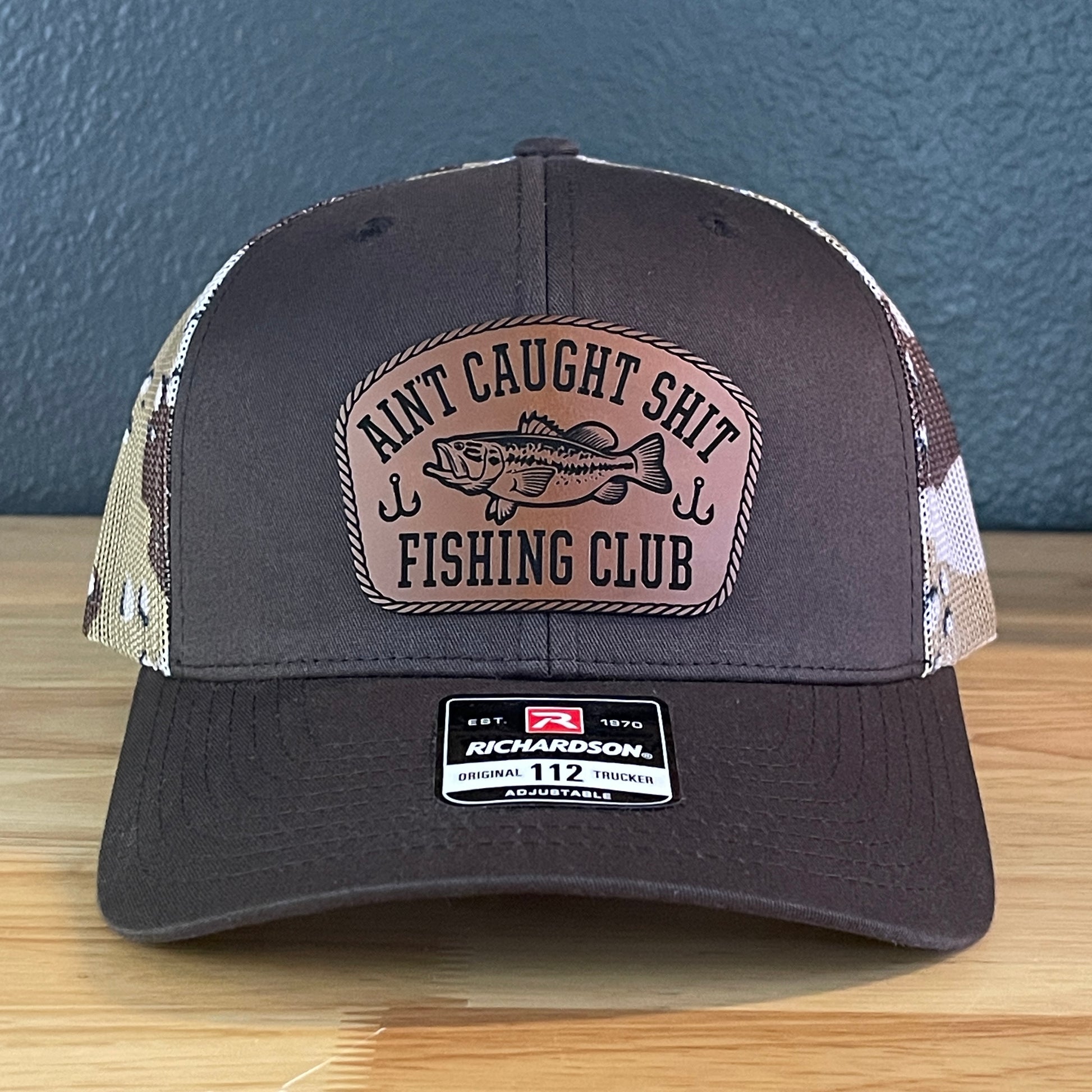 Ain't Caught Shit Fishing Club Leather Patch Trucker Hat. Richardson 112.